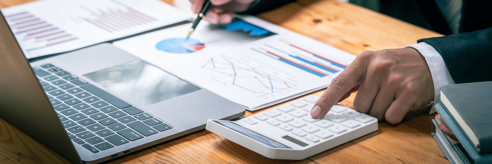 accountant working on a desk using calculator for calculating finance report in office, Annual tax c